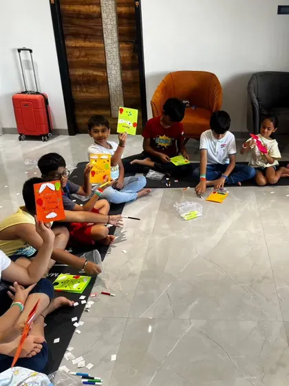 Kids in our Chennai workshop proudly hold up the greeting cards they made. This was part of our Independence Day session where they learned about circuits and lights.