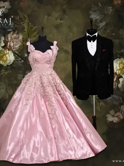 A captivating and timeless look for any couple. The sharp lines of the groom's black tuxedo are softened by the romantic silhouette and delicate embellishments of the bride's peach gown.