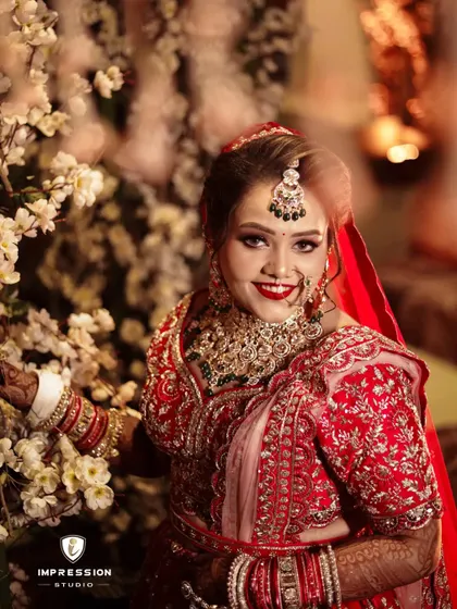 Capturing the enchanting beauty of a bride on her special day, smiling happily amidst a backdrop of white flowers.