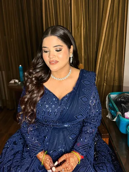 A beautiful Sangeet look in a royal blue gown. The makeup is soft and elegant, with a focus on a flawless base and a gentle smokey eye.