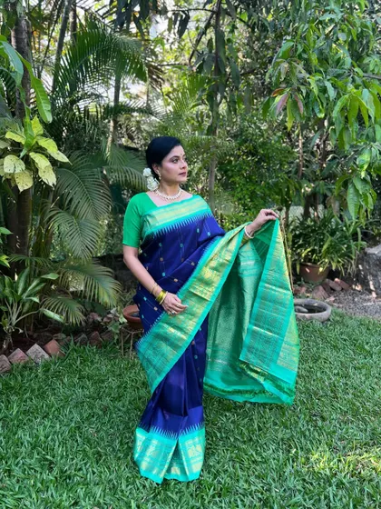 A full-length shot of Bhargavi in her stunning blue and green silk saree.
