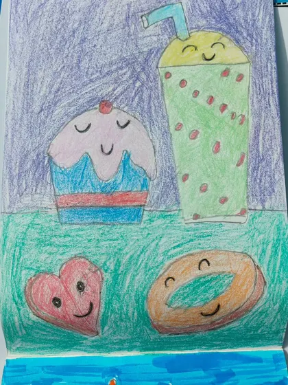 A close-up of the cute dessert drawings, where even the food has a smiling face.