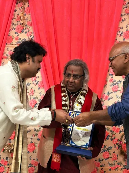 Another view of the felicitation, capturing the respect and warmth of the moment.