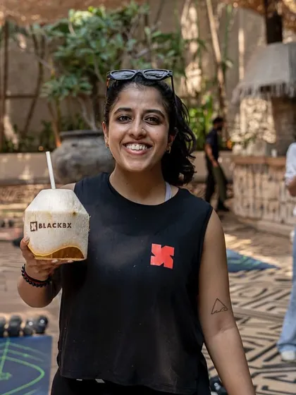 A happy member enjoying a post-workout coconut water at our outdoor event. It's about working hard and refueling right.