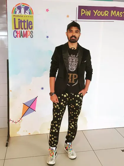 A stylish pose at a 'Little Champs' event. I always dress to impress and bring my unique fashion sense to every function.