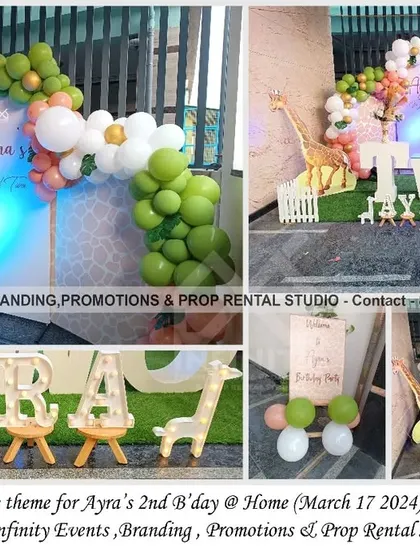 This sweet and simple giraffe theme for a 2nd birthday at home features a semi-arch backdrop with a pastel balloon garland. A large "TWO" table and giraffe props complete this charming and intimate setup.