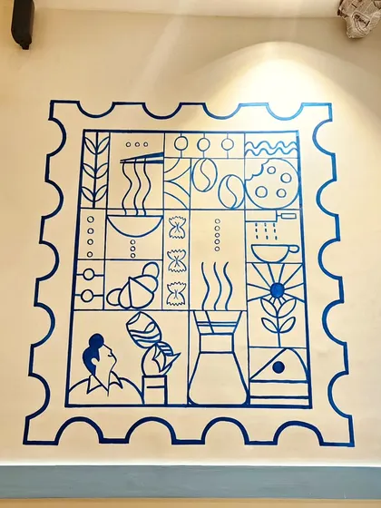 This minimalist 'duty free stamp' mural was designed for a cafe, incorporating elements like coffee, pasta, and croissants into a clever, graphic composition.