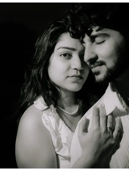 An intense and soulful black and white portrait. The close framing and dramatic lighting create a timeless and emotional image that focuses on their deep connection.