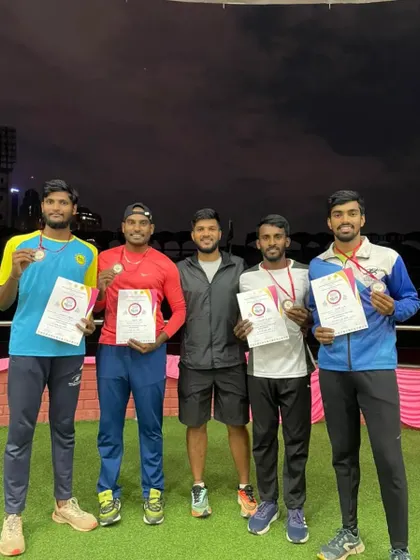 The men's 4x400m relay team after securing a bronze medal at the Dasara Meet, pictured with their coach.