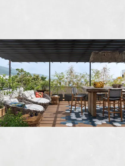 The social area of the Kamala Residence terrace, featuring a high-top bar table and comfortable lounge seating, perfect for hosting gatherings with a view.
