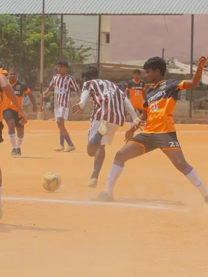 The intensity of a C-Division match is palpable as players challenge for possession in a cloud of dust. We train our players to be tough in all conditions.