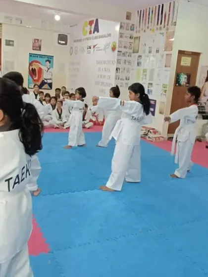 Students practicing a middle block, seen from the side.