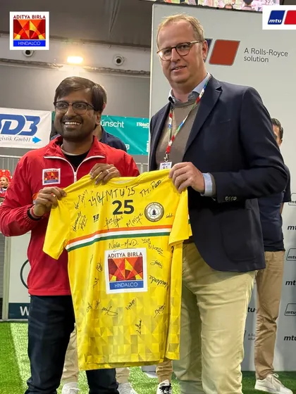 Receiving the Fair Play Award at the MTU Cup from the CEO of Rolls-Royce Power Systems AG. This award recognizes our commitment to sportsmanship and respect.