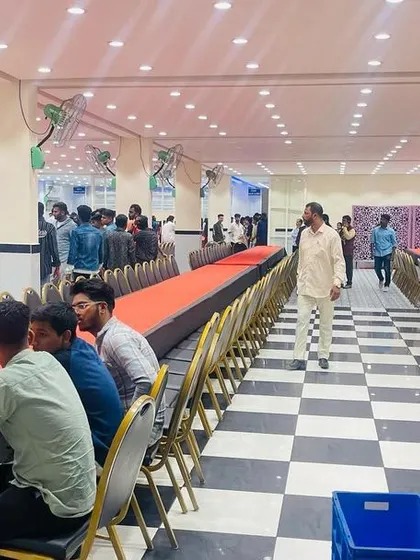 Setting up for a college farewell party at Karnataka College of Pharmacy. We can arrange long tables for a large number of students, perfect for fests and college events.