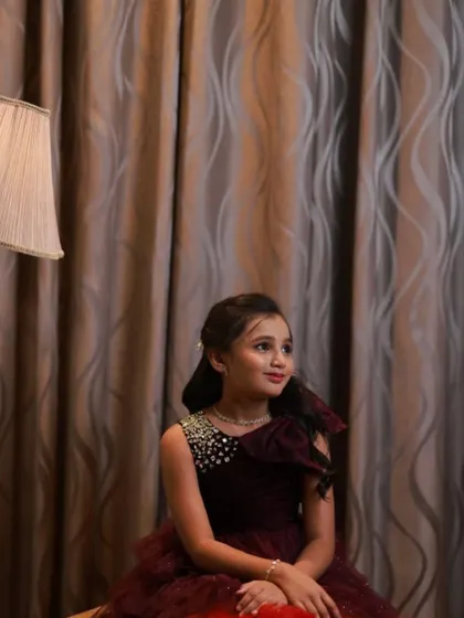 A close-up of the birthday girl's gown, showing the beaded bodice and one-shoulder design.