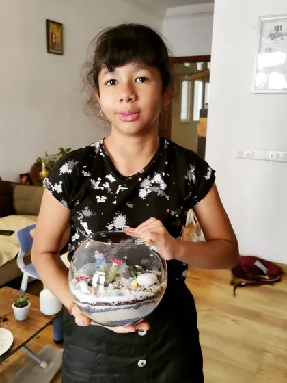 Another young creator with her finished terrarium. It's amazing to see the different ways kids express their creativity with the same set of materials.