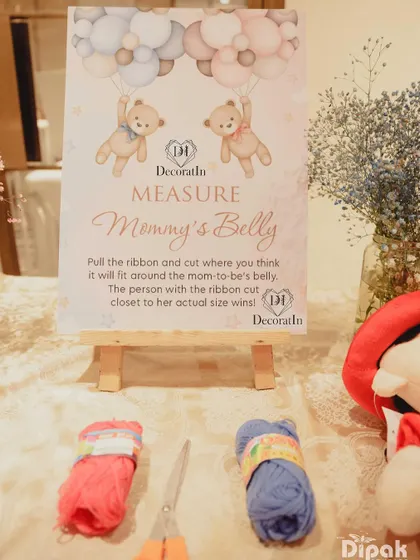 A "Measure Mommy's Belly" game, where guests guess the size of the baby bump.