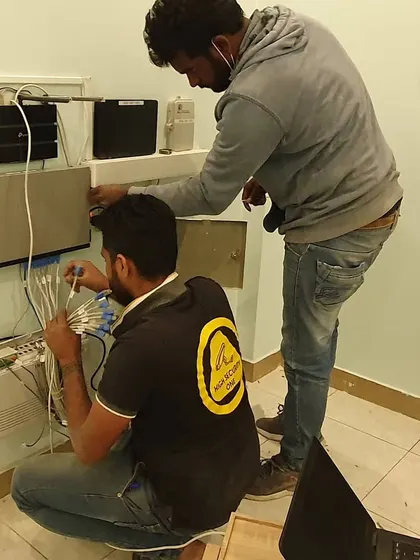 Two of my team members working on a complex network and intercom wiring setup. We handle all the low-voltage wiring required for your system.