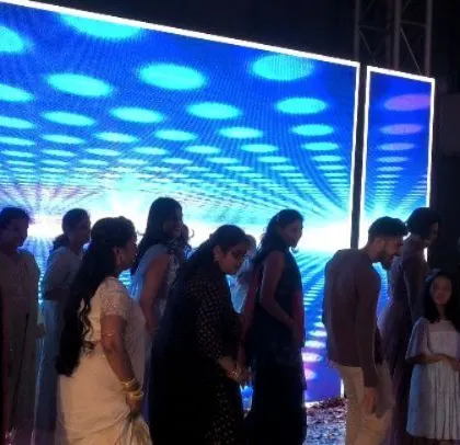 A group of ladies enjoying a dance performance on stage.