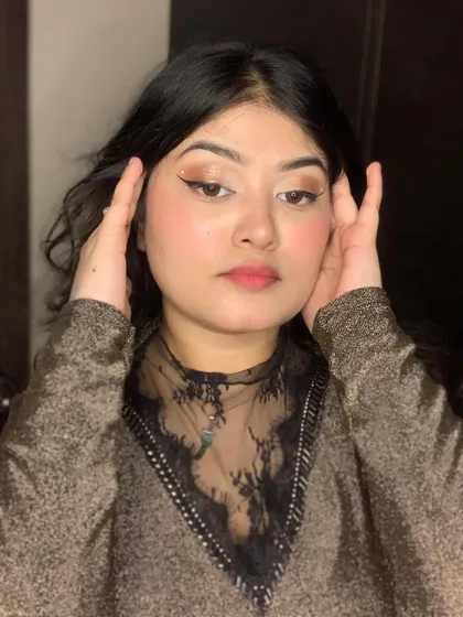 A close-up of a soft brown eye makeup look with a creative liner detail.