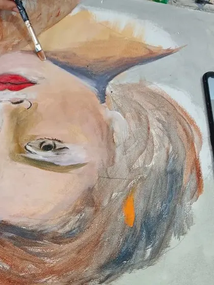 Watch a student bring a portrait to life with acrylics. This work-in-progress shows the process of layering colors from a photo reference to build up skin tones and facial features on canvas.