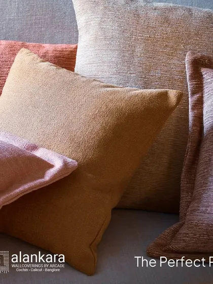 A close-up of cushions made from the Melford & Maycott fabrics. The image highlights the slubby, iridescent texture and the warm, inviting colorways available in this collection.