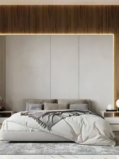 A serene and minimalist bedroom design featuring a wood-paneled accent wall with integrated strip lighting. The low-profile bed and simple side tables create a clean, uncluttered space perfect for relaxation.