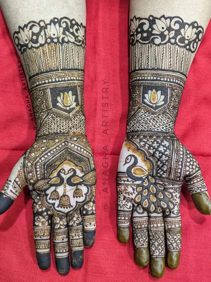 A semi-bridal design that is both intricate and elegant. It features beautiful peacock and lotus motifs, perfect for an engagement or other pre-wedding ceremony.