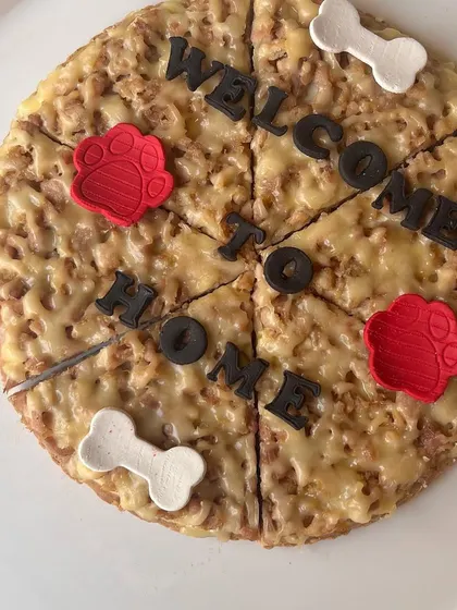 A "Welcome to Home" pizza-style cake, another one of our creations to celebrate milestones and special moments with our wonderful community.