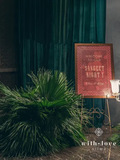 The welcome signage for the sangeet, designed with a classic font and color palette to match the elegant, art-inspired theme.