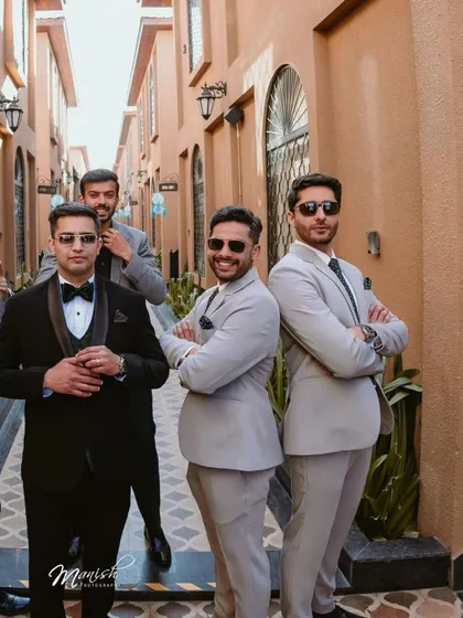 The groom and his groomsmen posing with style, a great example of creative and fun group photography.