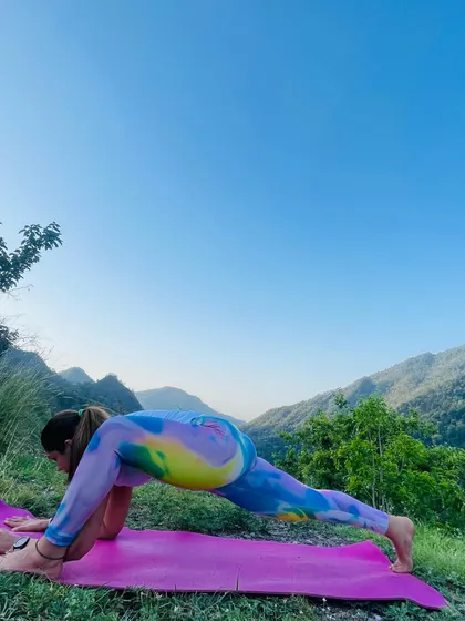 A deep stretch in Lizard Pose (Utthan Pristhasana) against a stunning mountain backdrop. This pose is excellent for opening the hips and groin.