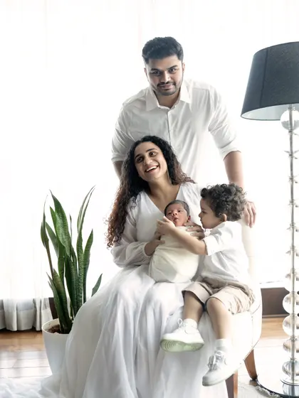 A complete family portrait celebrating their newest member. The older sibling is so gentle with the baby, showcasing the beautiful bond that is already forming between them.