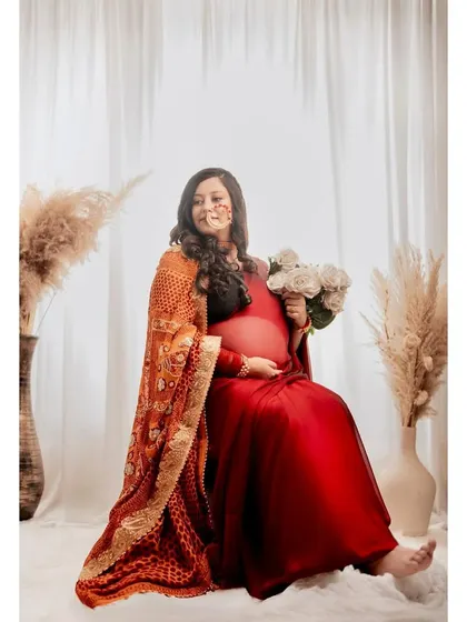 Another take on the graceful seated pose, showing the mom-to-be's calm and happy demeanor.