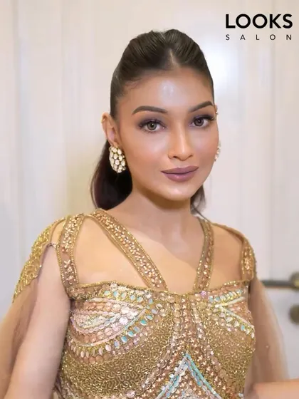 A close-up of the sleek ponytail and makeup. The look is clean, modern, and very chic, perfect for a fashion-forward client attending a special event.