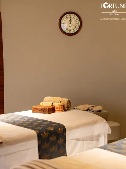 A close-up of a prepared massage bed, highlighting the fresh linens and neatly arranged accessories. I ensure every detail is perfect for your arrival.