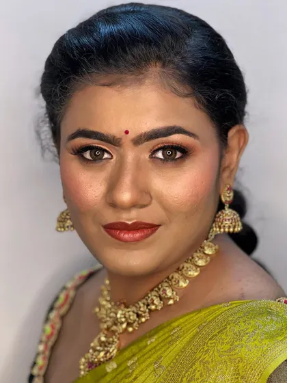 A smiling portrait of Nikki. The makeup enhances her warm skin tone and gives her a beautiful, festive glow.