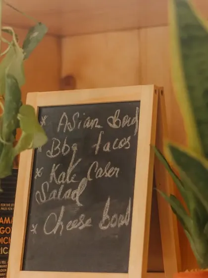 A little corner of the cafe that captures our essence. A chalkboard with menu specials sits between books and plants, showing our love for fresh food, reading, and nature.