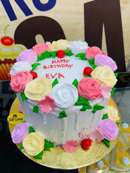 A 2kg floral cake covered in a bouquet of multicolored buttercream roses.