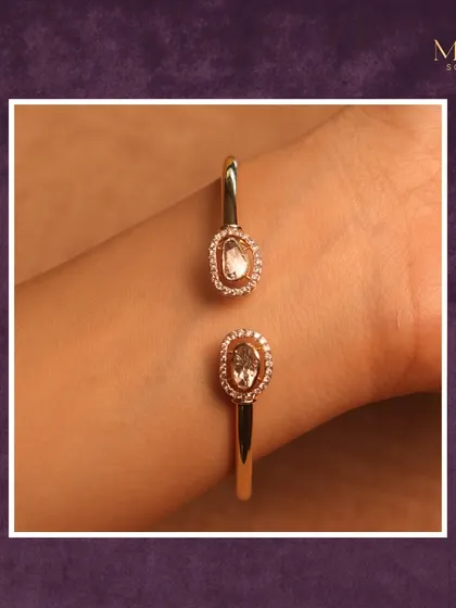 Subtle sophistication at its finest. This modern gold cuff bracelet features two beautiful Polki diamonds in a halo setting. It's a statement of modern grace that adds a refined sparkle to any look.