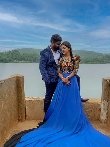 A stunning couple's portrait by the water, showcasing our royal blue trail gown paired with a patterned designer blazer. This combination is perfect for creating memorable pre-wedding photography.