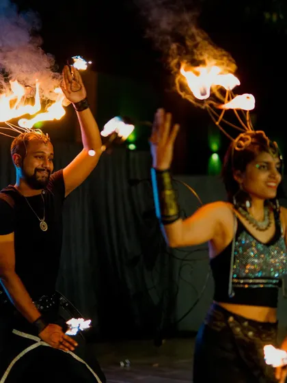 A duo of fire performers entertaining guests at a wedding reception. Capturing high-energy acts like this adds a unique and exciting element to your wedding gallery.