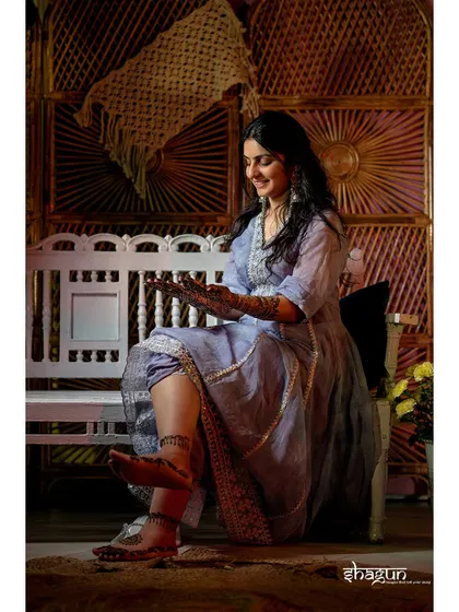 Another shot of the bride admiring her mehndi, a beautiful tradition captured in a quiet, personal moment.