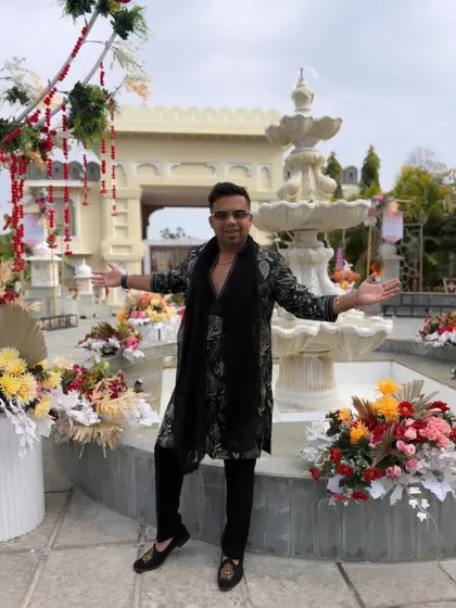 Welcome to the celebration! With open arms, I'm ready to greet the Baaraatis and get them dancing before they even step inside the venue.