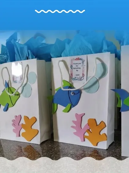 Custom return favor bags for the 'Under the Sea' party, decorated with foam sea creatures.