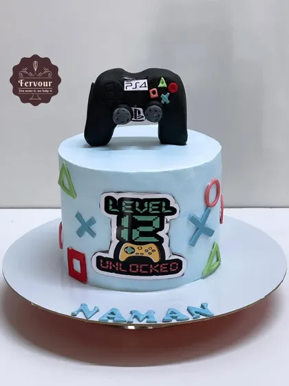A PS4-themed cake with a hand-molded fondant controller on top. The "Level 12 Unlocked" message makes it a perfect cake for a pre-teen's birthday.