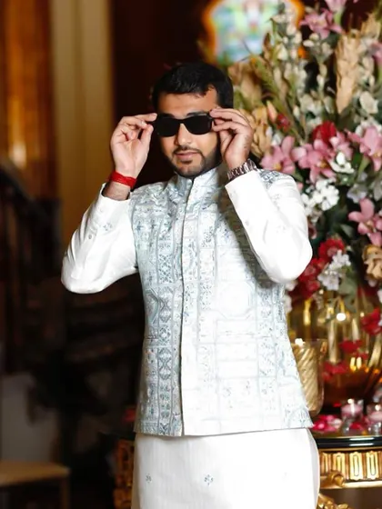A stylish pose showing the confidence that comes with a well-fitted, elegant ethnic outfit. The sunglasses add a touch of modern flair.