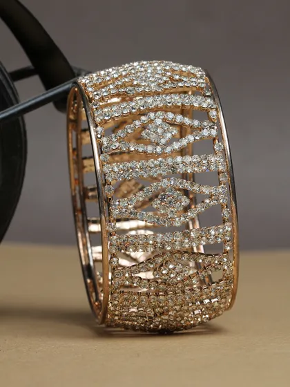 A broad, cuff-style bangle completely covered in sparkling stones.