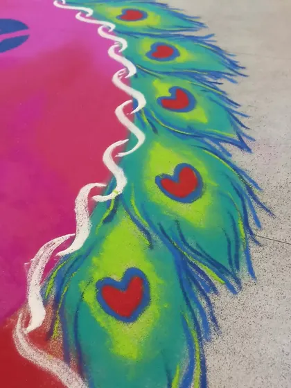 A detail of the peacock feather border, where I've added small hearts for a creative touch. This shows how I can add small, custom details to make a design unique.
