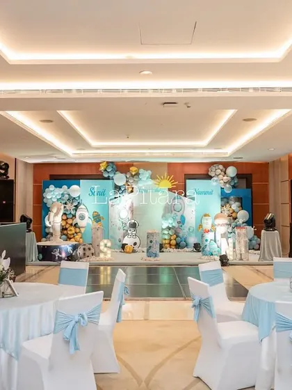 The indoor dining area, with tables and chairs decorated in shades of blue and white to match the celestial theme.